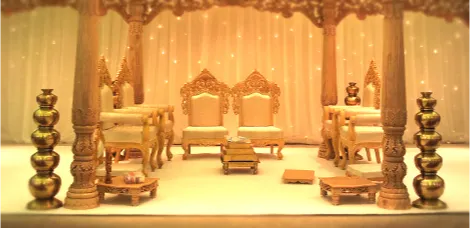 An ornate traditional Asian wedding mandap stage, showcasing vendors from an Asian wedding directory.